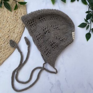 Gebreid babymutsje Bonnet van Merinowol met kantrand en strikkoordje – handgemaakt door Little & Sweet